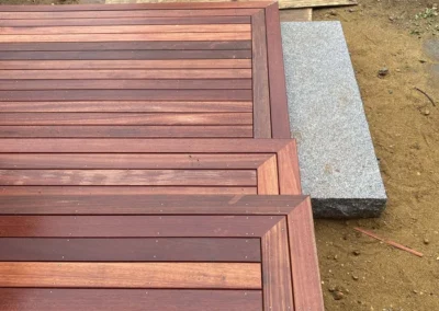 A neatly crafted wooden deck with detailed carpentry work, featuring precise alignment and rich wood tones.