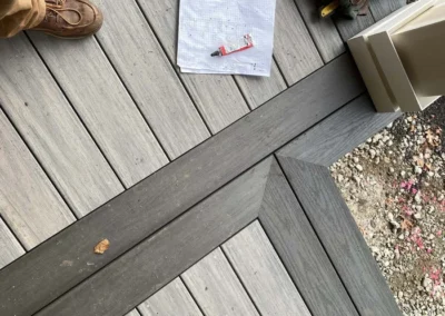 A custom carpentry project showing a detailed decking with tools, notes, and a work boot.